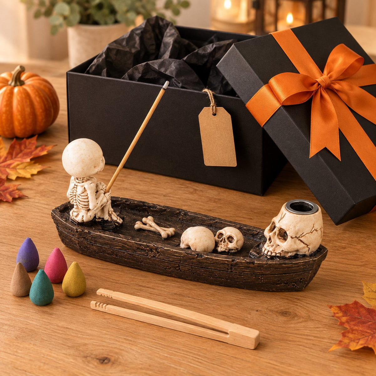 Pebetero Bote Esqueleto junto a una caja de regalo